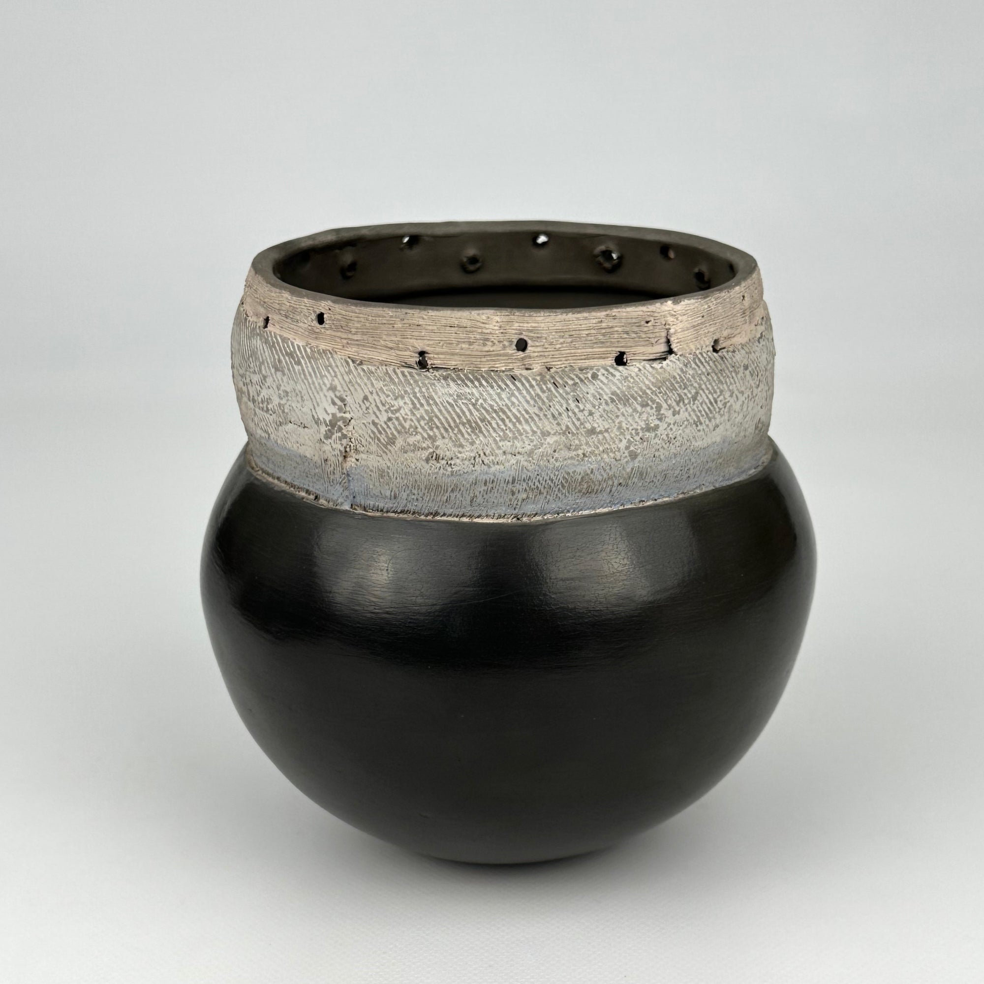 Black Vessel With Pierced Top